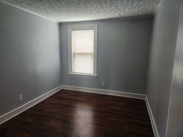280 Ridge Street Fall River, MA 02721 - Photo 4 of 13 an empty room with wooden floor and window