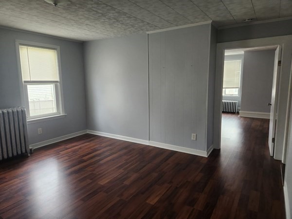 280 Ridge Street Fall River, MA 02721 - Photo 5 of 13 an empty room with wooden floor and windows