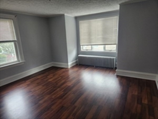 280 Ridge Street Fall River, MA 02721 - Photo 6 of 13 an empty room with wooden floor and windows