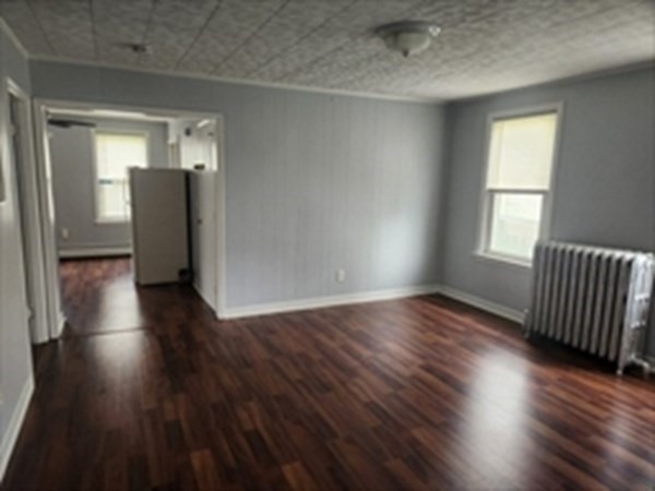 280 Ridge Street Fall River, MA 02721 - Photo 7 of 13 an empty room with wooden floor and windows