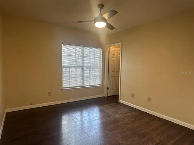 a view of wooden floor and windows in a room