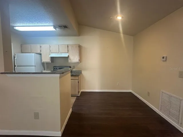 a view of a kitchen with a sink cabinets and wooden floor