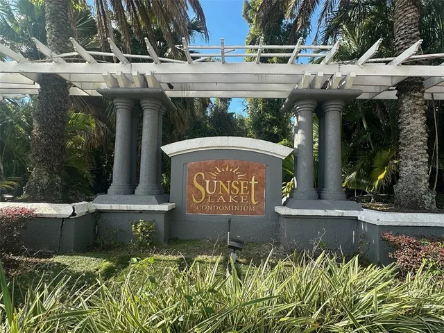 a view of a yard with plants and trees