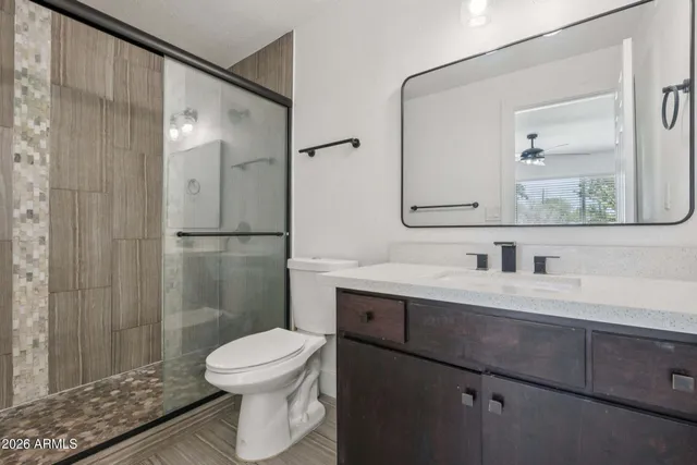 a bathroom with a toilet a sink and shower