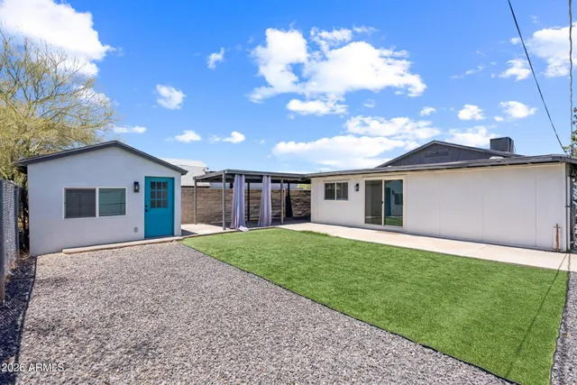 a front view of a house with a garden and yard