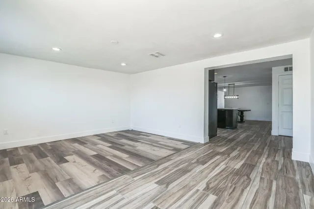 a view of a room with wooden floor