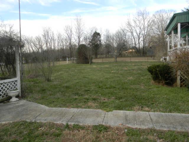 4805 Banner Adams Road College Grove, TN 37046 - Photo 5 of 20 You can see a little bit of the field which is on the right side of the home if you are standing at the road. There is fenced pasture land on both sides of the home and in the back as well.