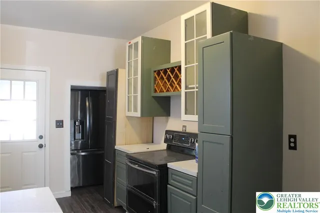 a kitchen with stainless steel appliances a refrigerator and a stove