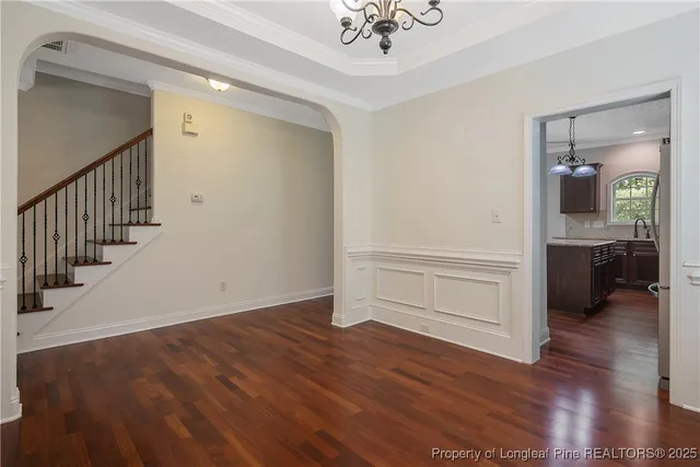 a view of a hallway view with wooden floor and staircase