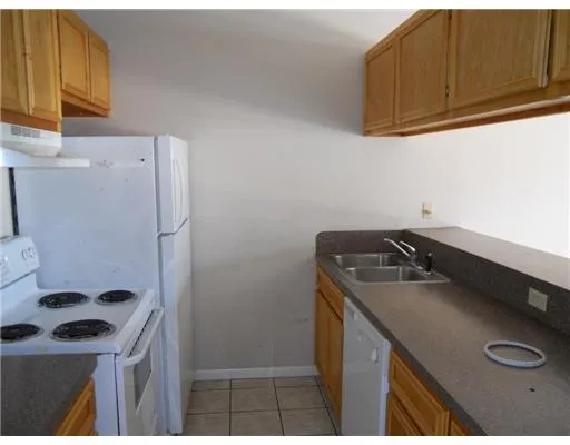a kitchen with a sink a stove and a refrigerator