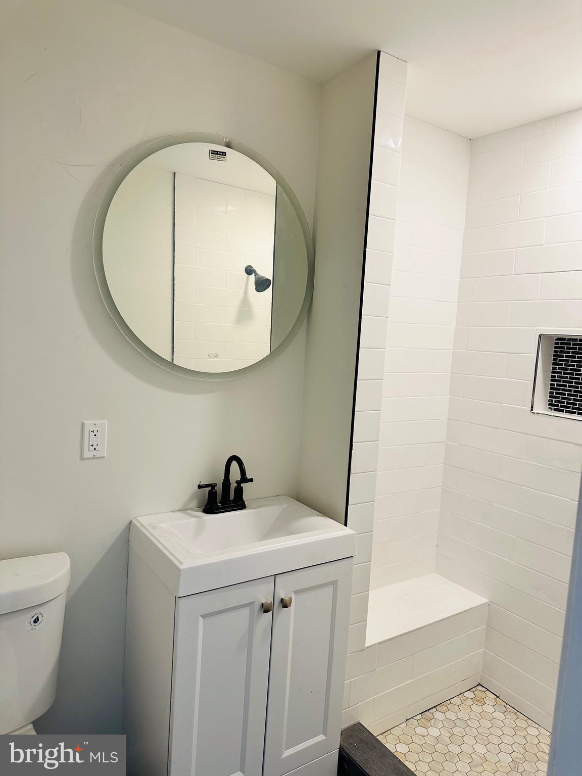 1921 Herbert Street Baltimore, MD 21217 - Photo 9 of 12 a bathroom with a sink a toilet and a mirror