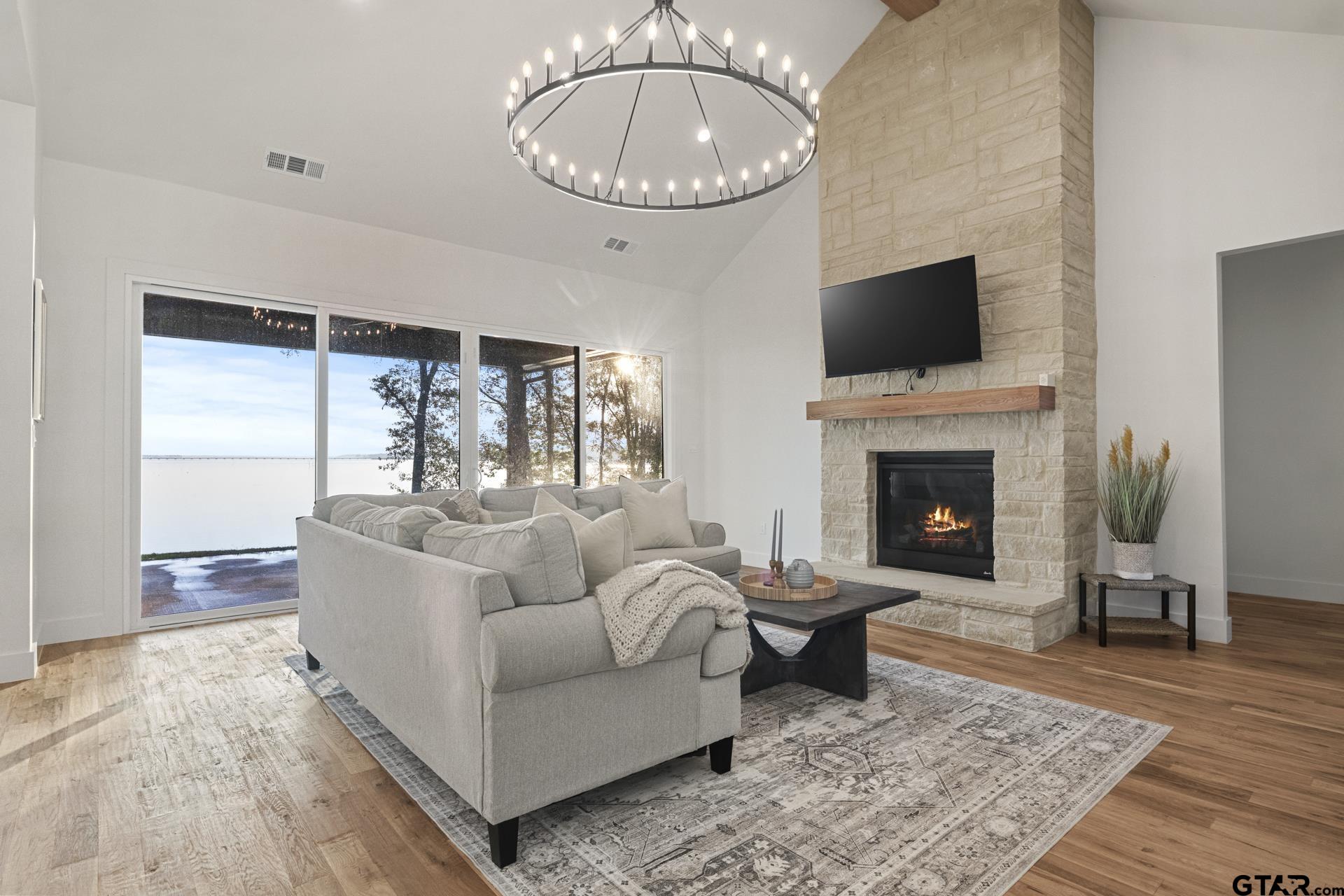 a living room with furniture a rug and a fireplace