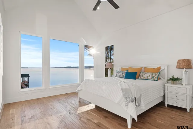 a bedroom with a bed and large window