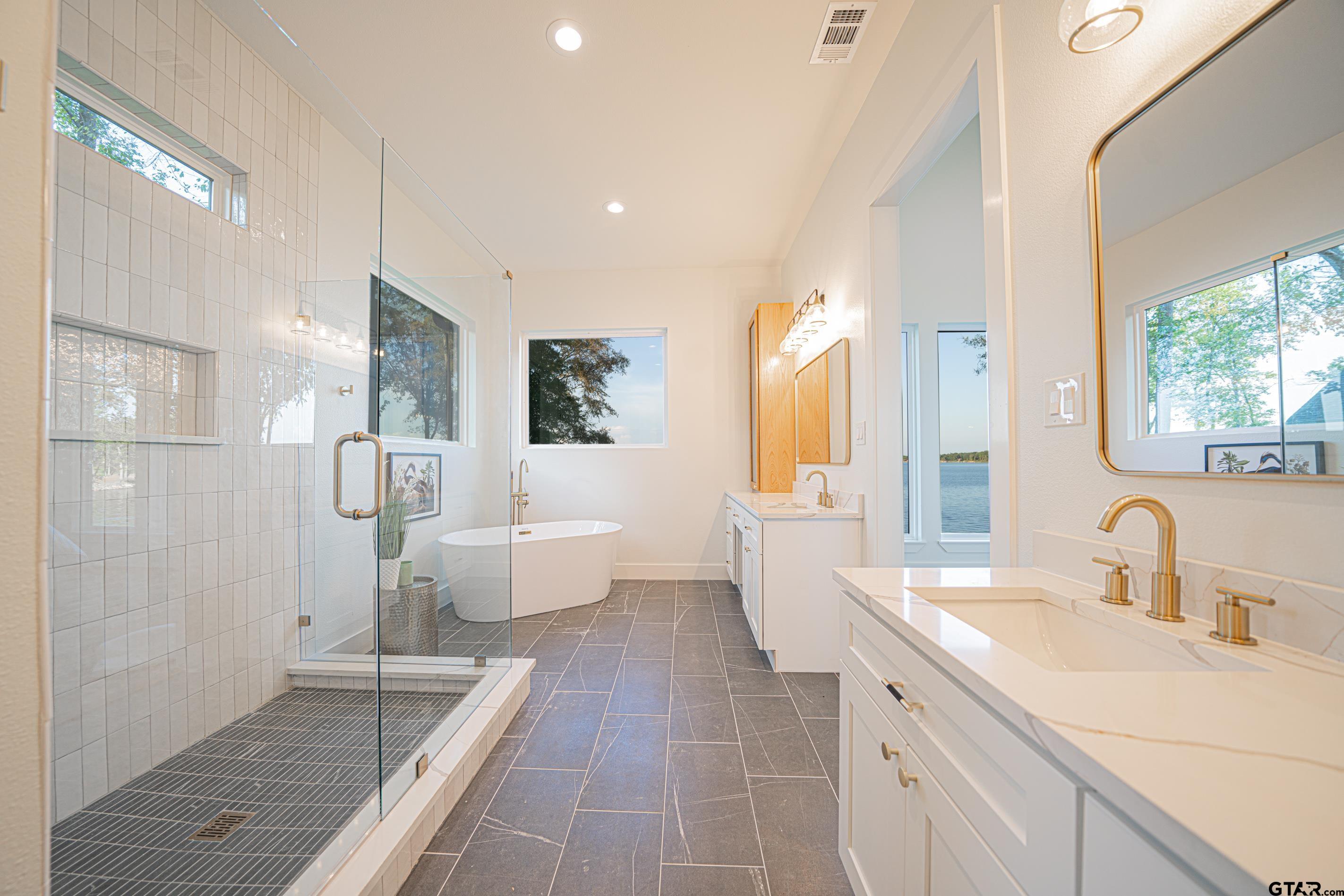 641 North Private Road Leesburg, TX 75451 - Photo 13 of 44 a spacious bathroom with a double vanity sink mirror and a shower