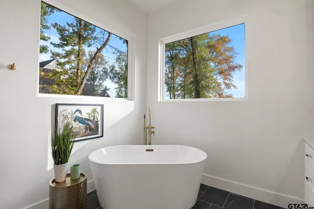 a white bath tub sitting next to a white sink