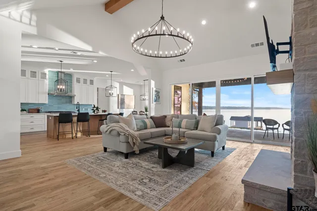 a living room with furniture kitchen view and a table