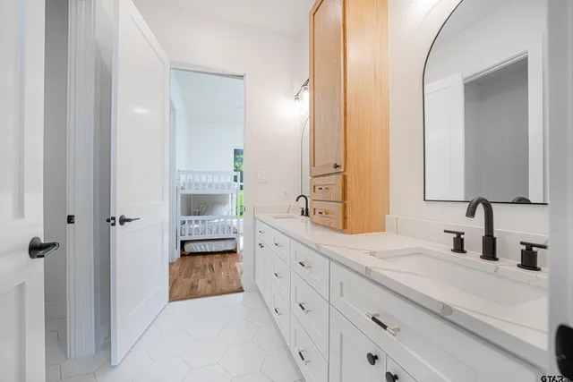 a bathroom with a double vanity sink and mirror