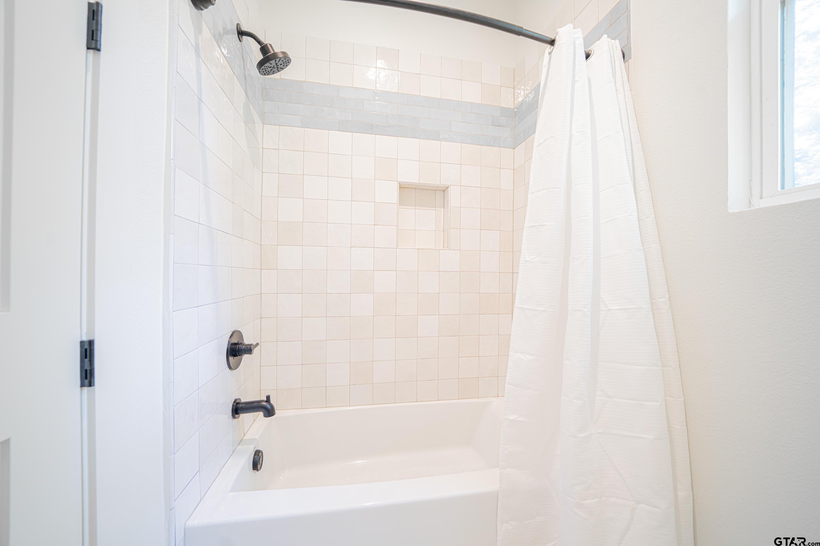 641 North Private Road Leesburg, TX 75451 - Photo 22 of 44 a bathroom with a shower and a bathtub