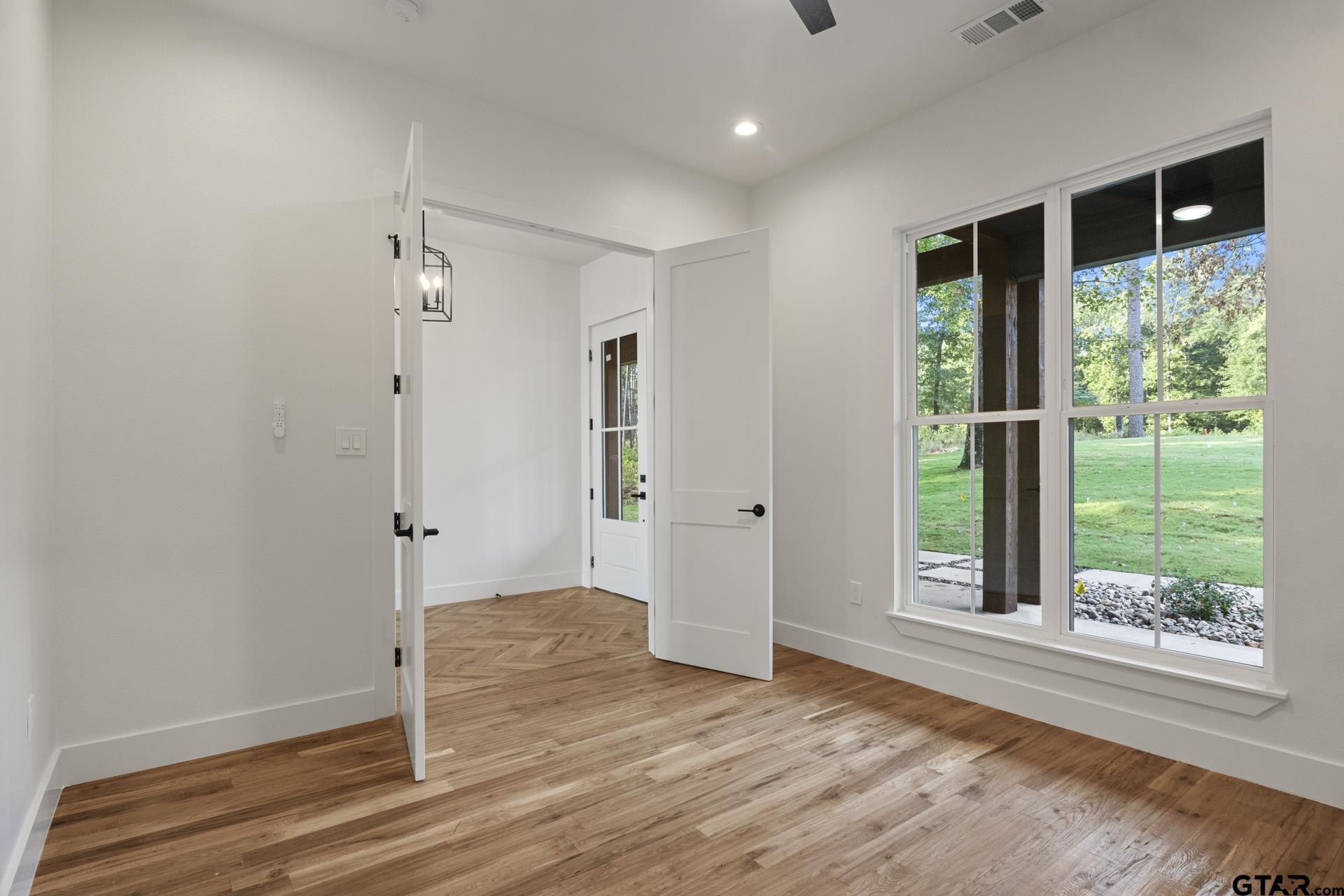 641 North Private Road Leesburg, TX 75451 - Photo 29 of 44 an empty room with wooden floor and windows