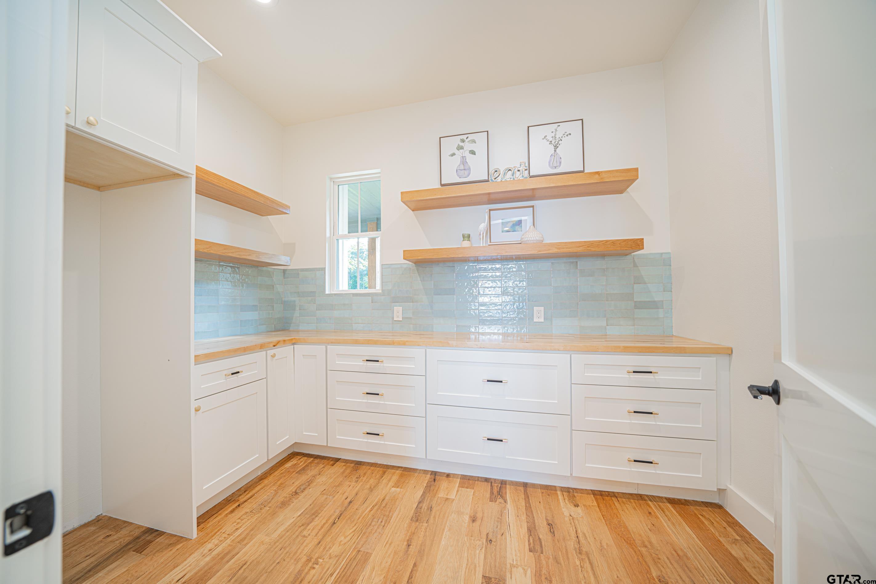 641 North Private Road Leesburg, TX 75451 - Photo 31 of 44 a kitchen with a cabinets and wooden floor