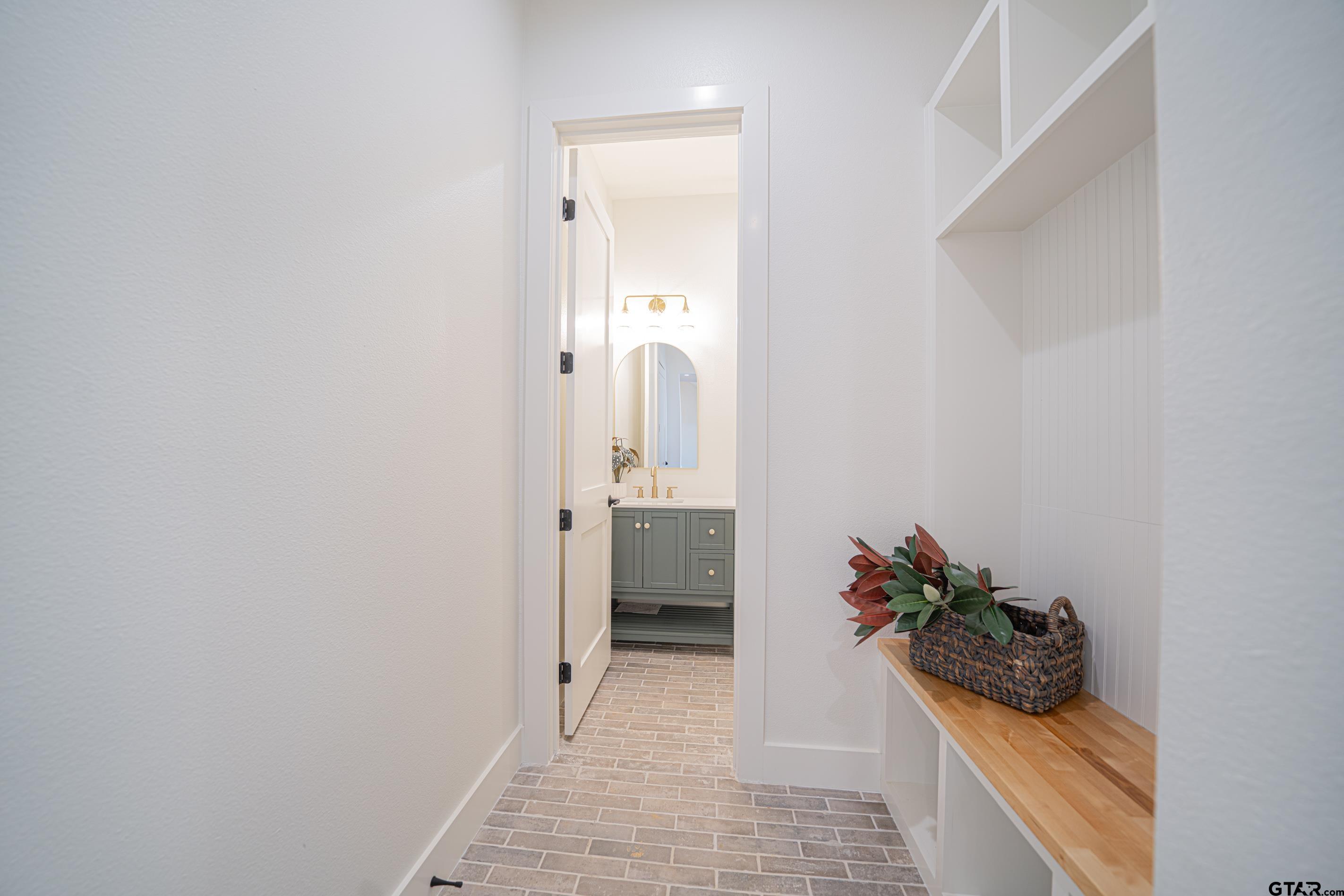 641 North Private Road Leesburg, TX 75451 - Photo 32 of 44 a view of a hallway with wooden floor and a bathroom