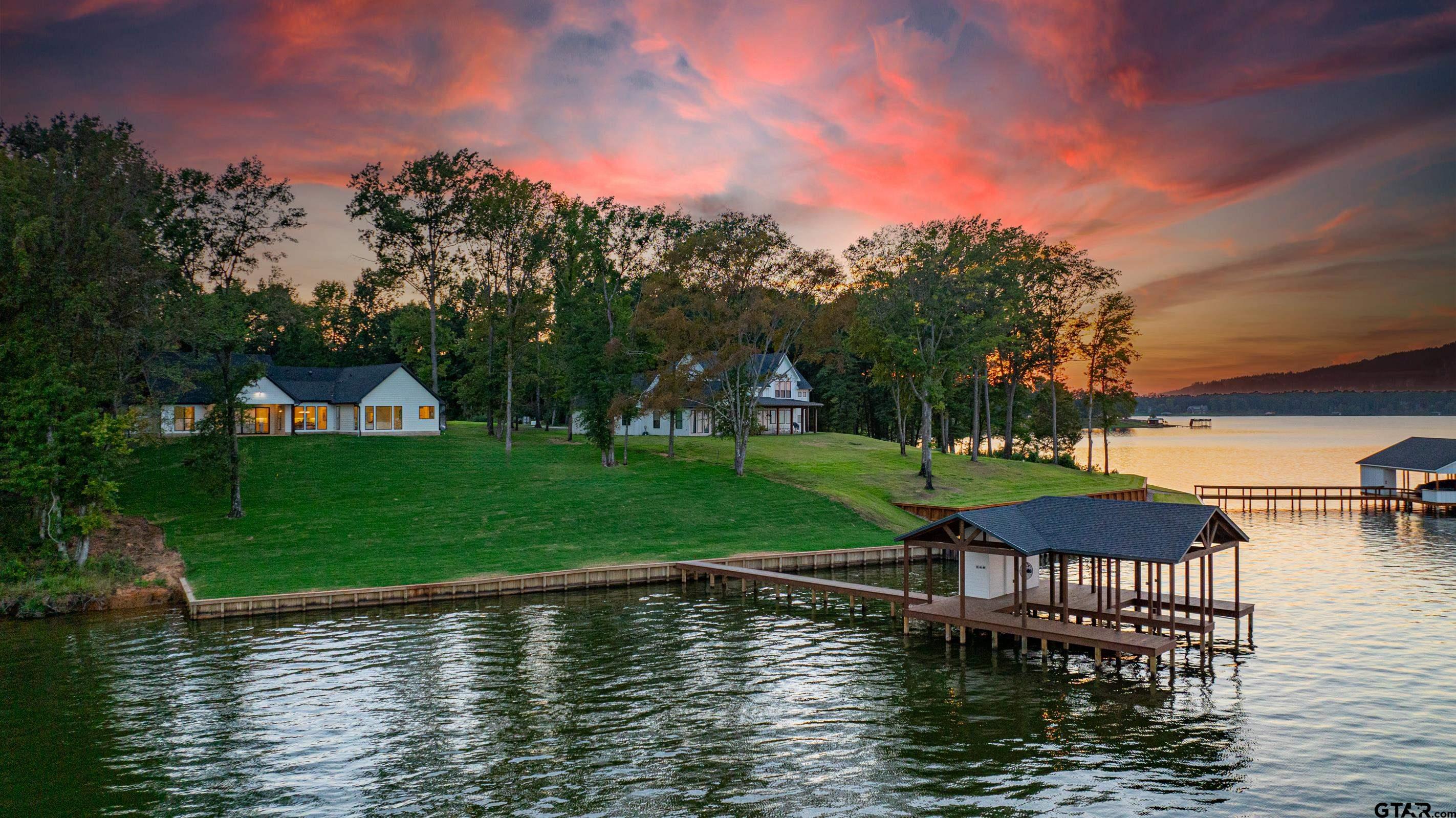 641 North Private Road Leesburg, TX 75451 - Photo 35 of 44 a view of a lake with a yard and large trees