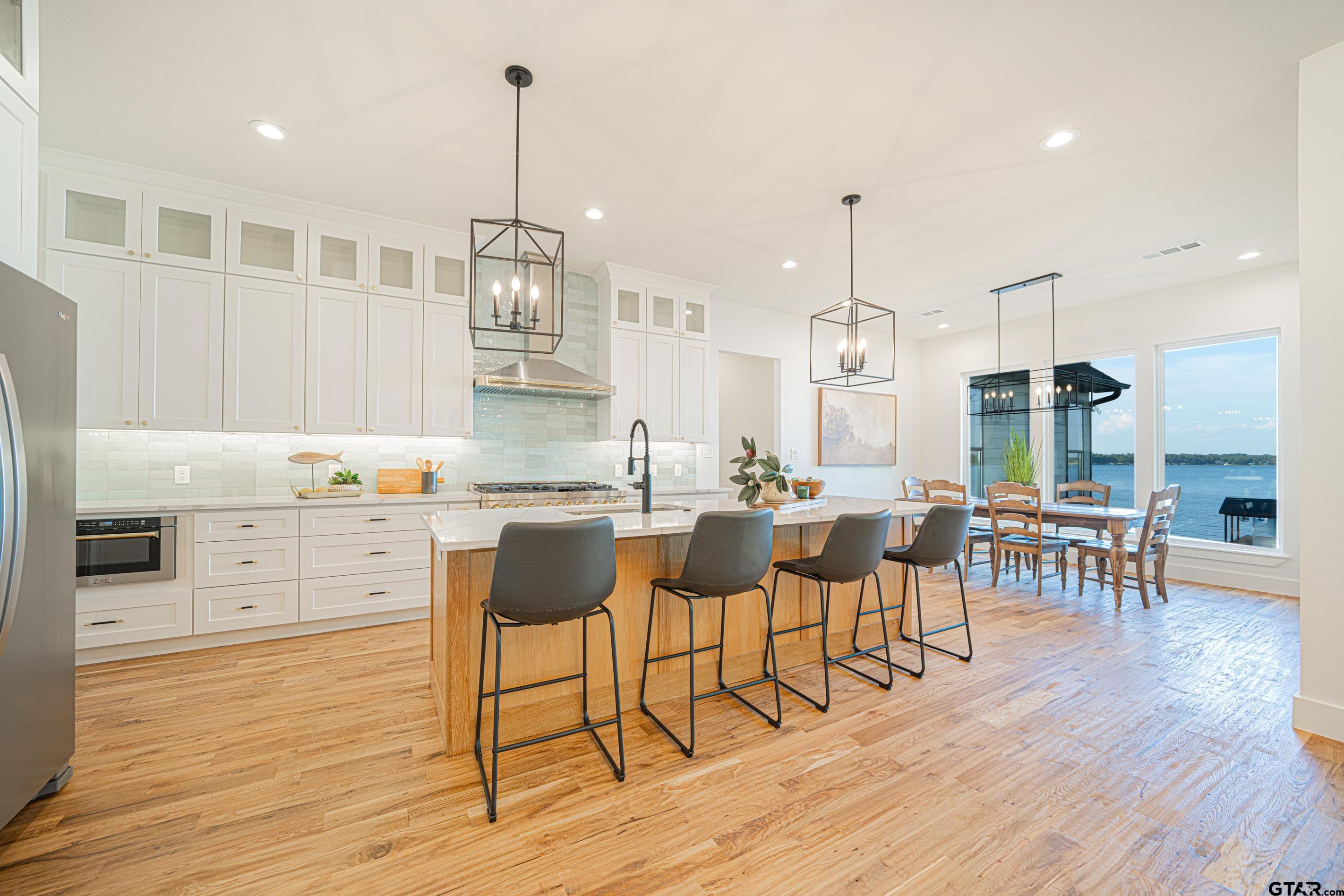 641 North Private Road Leesburg, TX 75451 - Photo 5 of 44 a open kitchen with stainless steel appliances granite countertop a dining table chairs stove and white cabinets