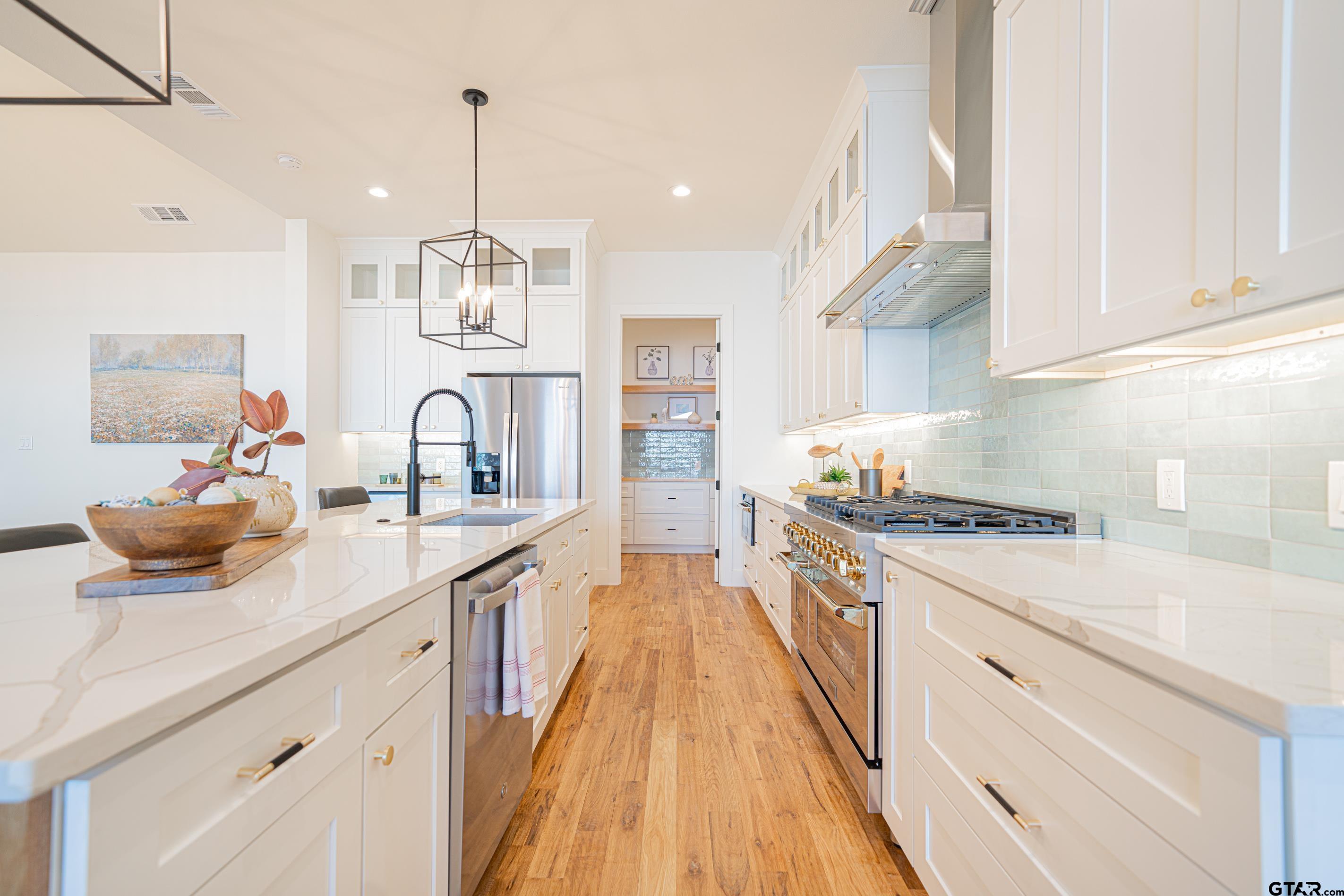 641 North Private Road Leesburg, TX 75451 - Photo 7 of 44 a kitchen with kitchen island a stove a sink and a refrigerator