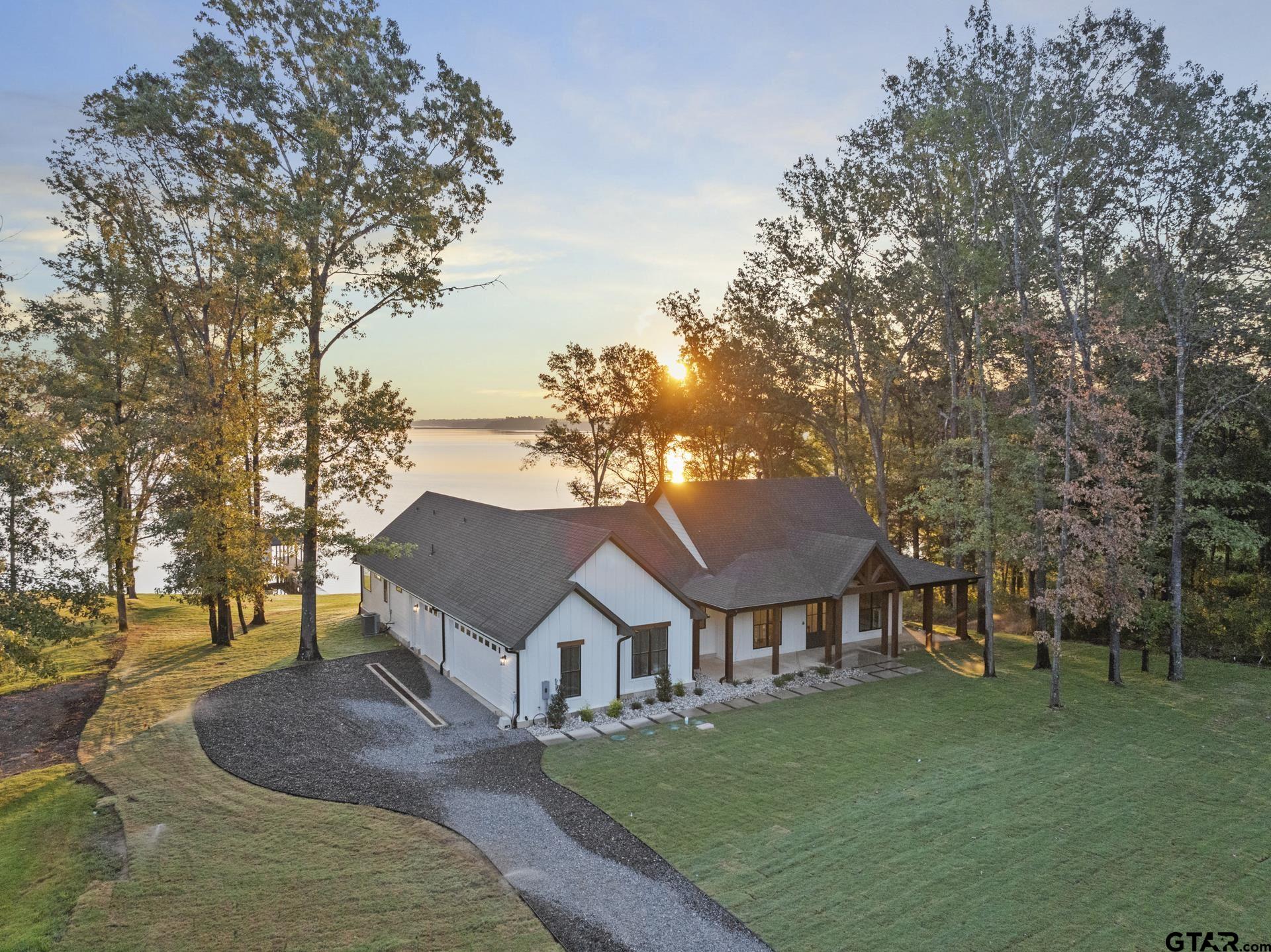 641 North Private Road Leesburg, TX 75451 - Photo 10 of 44 a front view of a house with a garden and tree