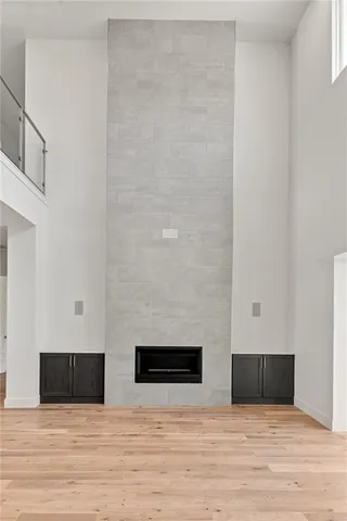 a view of empty room with wooden floor and windows