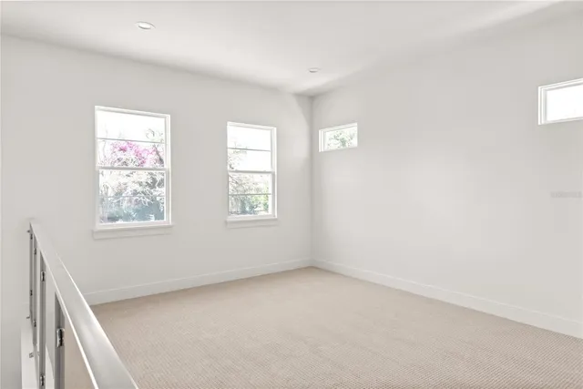 a bathroom with a double vanity sink a toilet a mirror and shower