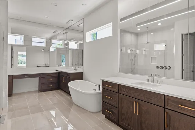 a white bath tub sitting next to a white sink