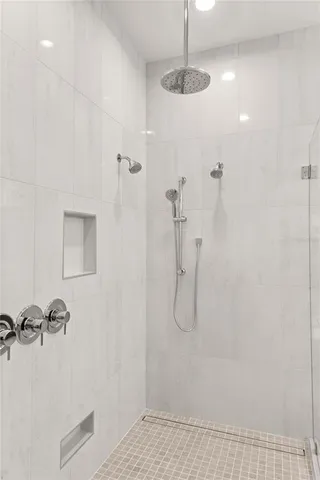 a bathroom with a shower and a glass door