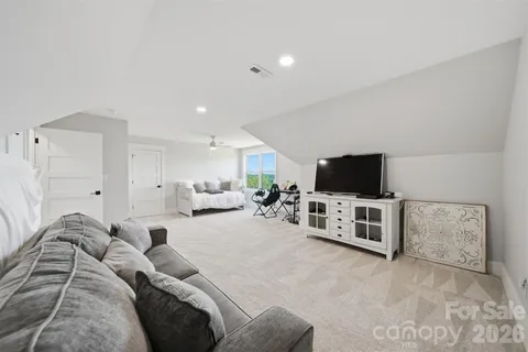 a living room with furniture and white walls