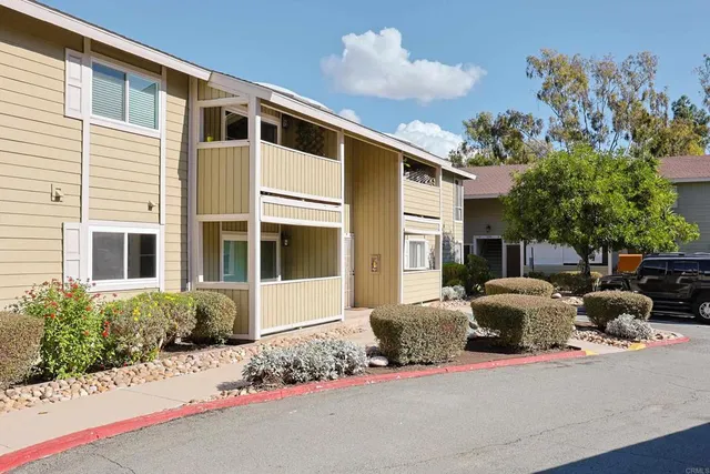a front view of a house with a yard and glass windows