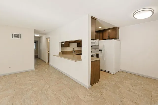 a view of a living room with furniture and flat screen tv