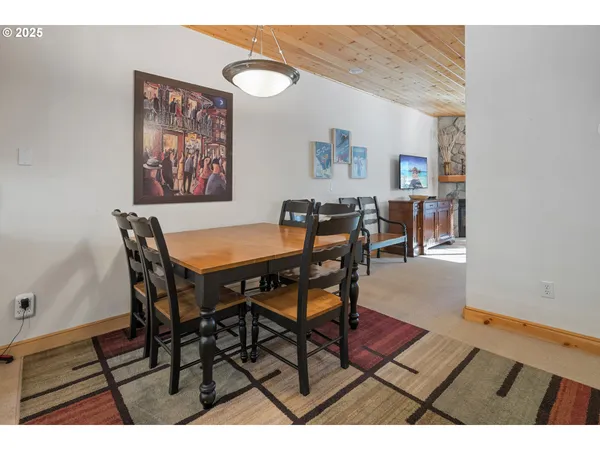 a view of a dining room with furniture and a chandelier