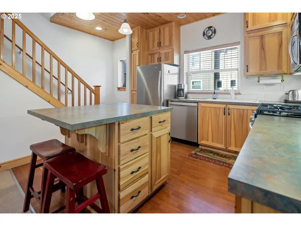a kitchen with cabinets appliances and a counter