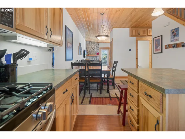 a kitchen with stainless steel appliances granite countertop a stove and cabinets