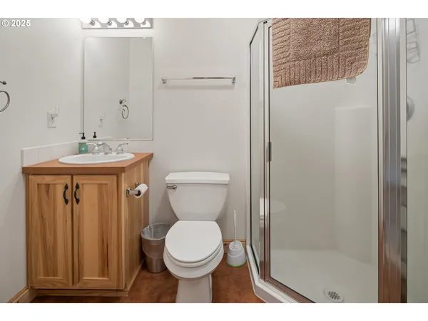 a bathroom with a toilet a sink and a shower