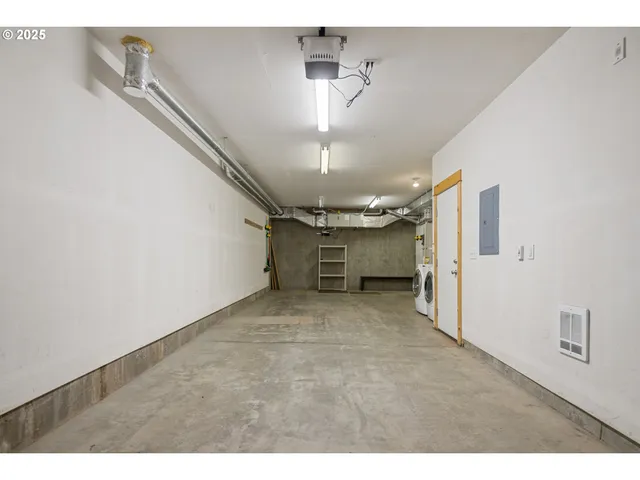 a view of a big room with chandelier fan and windows