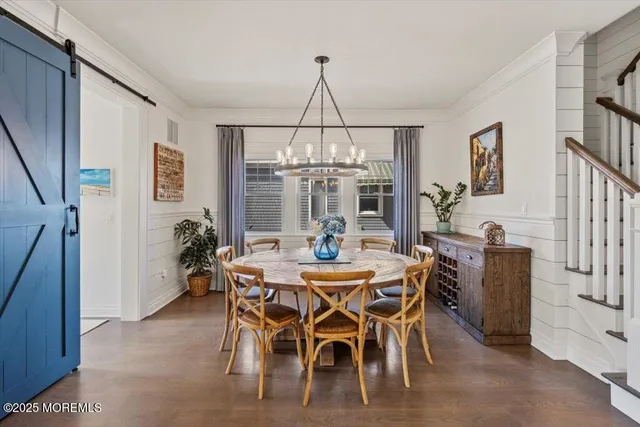 a dining room with furniture a chandelier and window