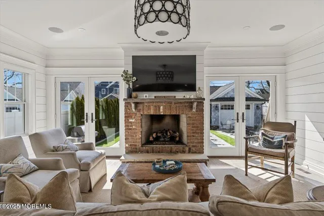 a living room with furniture a flat screen tv and a fireplace