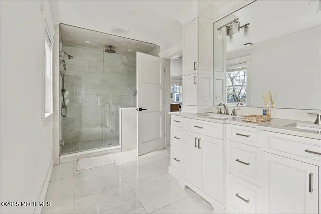 a bathroom with a shower sink and mirror