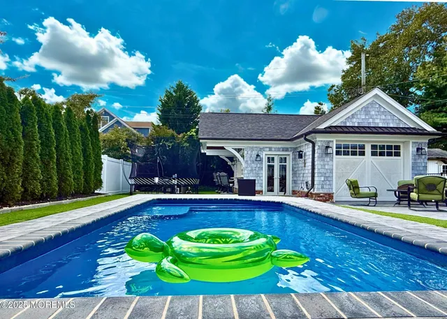 a view of a house with swimming pool yard and patio
