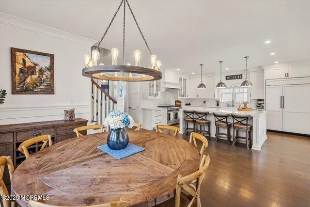 a kitchen with stainless steel appliances granite countertop a sink a stove and a wooden floors