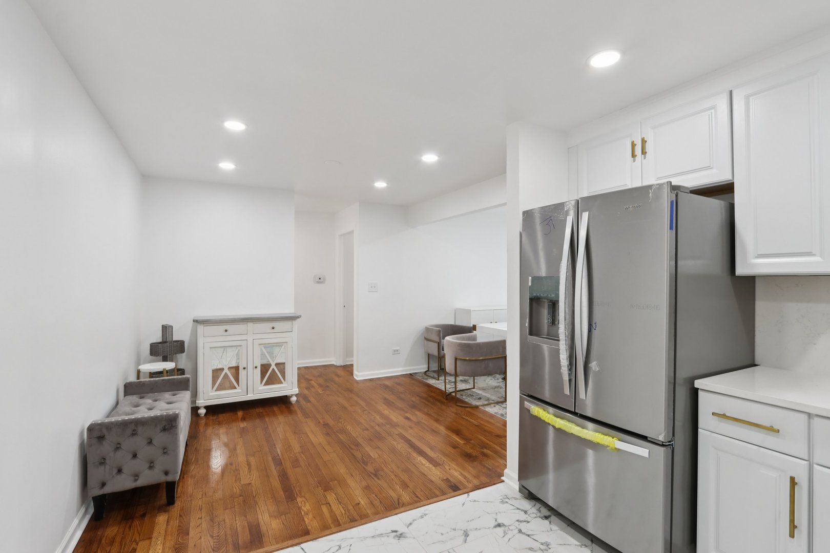 8916 Kenneth Drive, Unit 1E Des Plaines, IL 60016 - Photo 12 of 27 a kitchen with stainless steel appliances a refrigerator and wooden floor