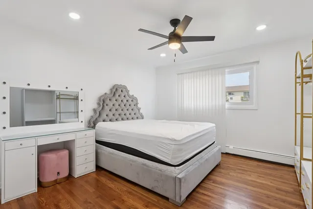 a spacious bedroom with a bed and a chandelier