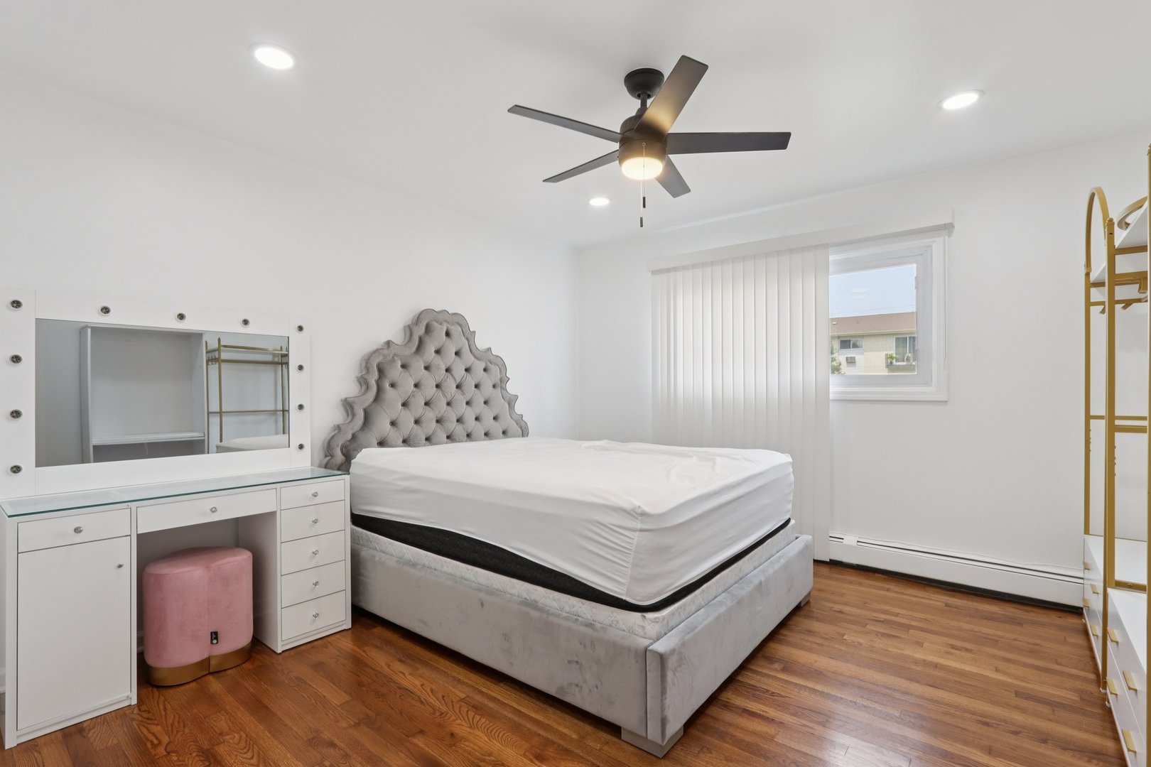 8916 Kenneth Drive, Unit 1E Des Plaines, IL 60016 - Photo 14 of 27 a spacious bedroom with a bed and a chandelier