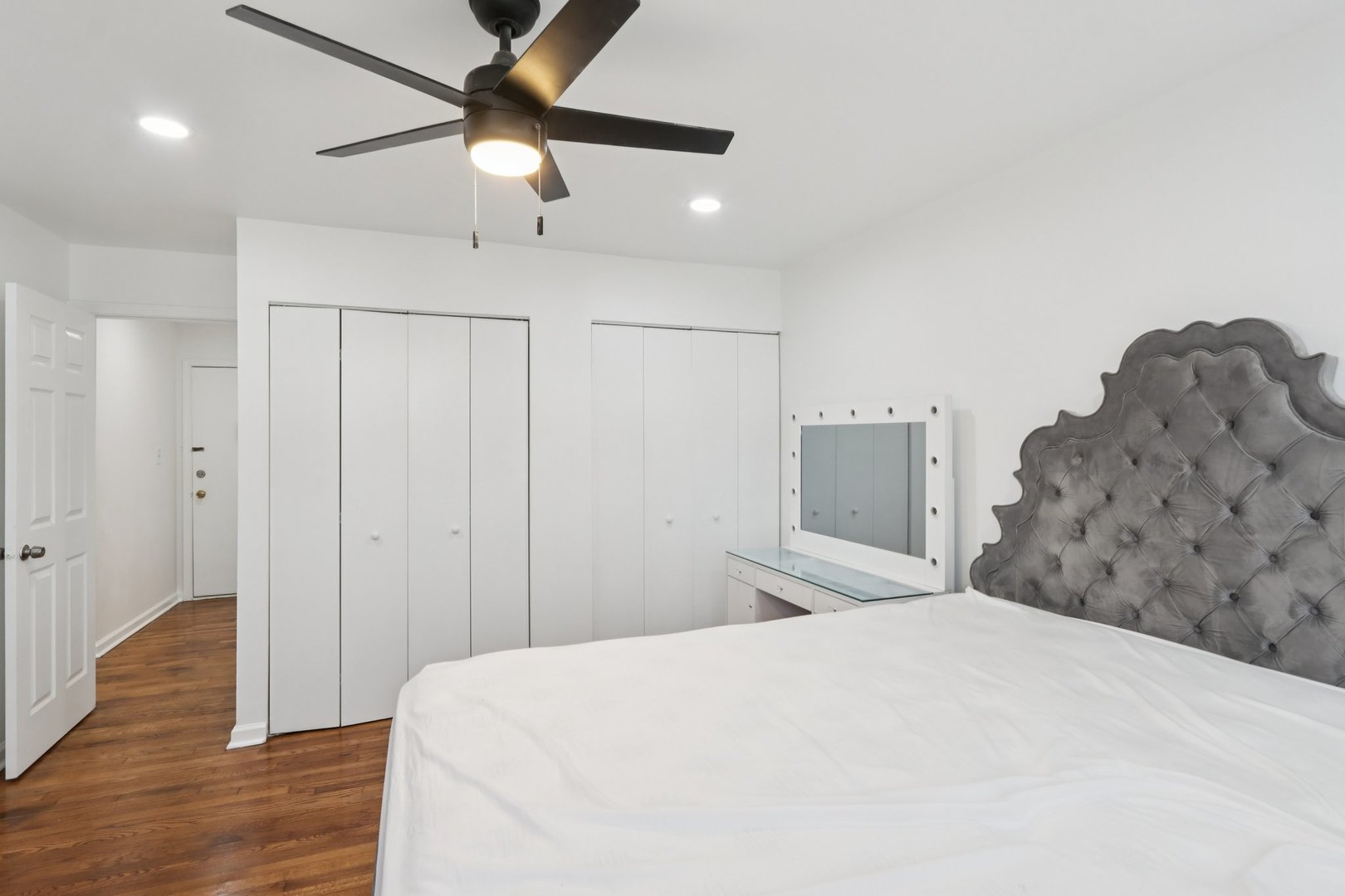 8916 Kenneth Drive, Unit 1E Des Plaines, IL 60016 - Photo 15 of 27 a bedroom with a bed and a chandelier